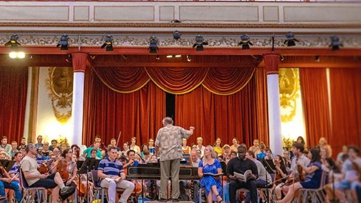 Professor conducts the Trinity orchestra during a performance. 