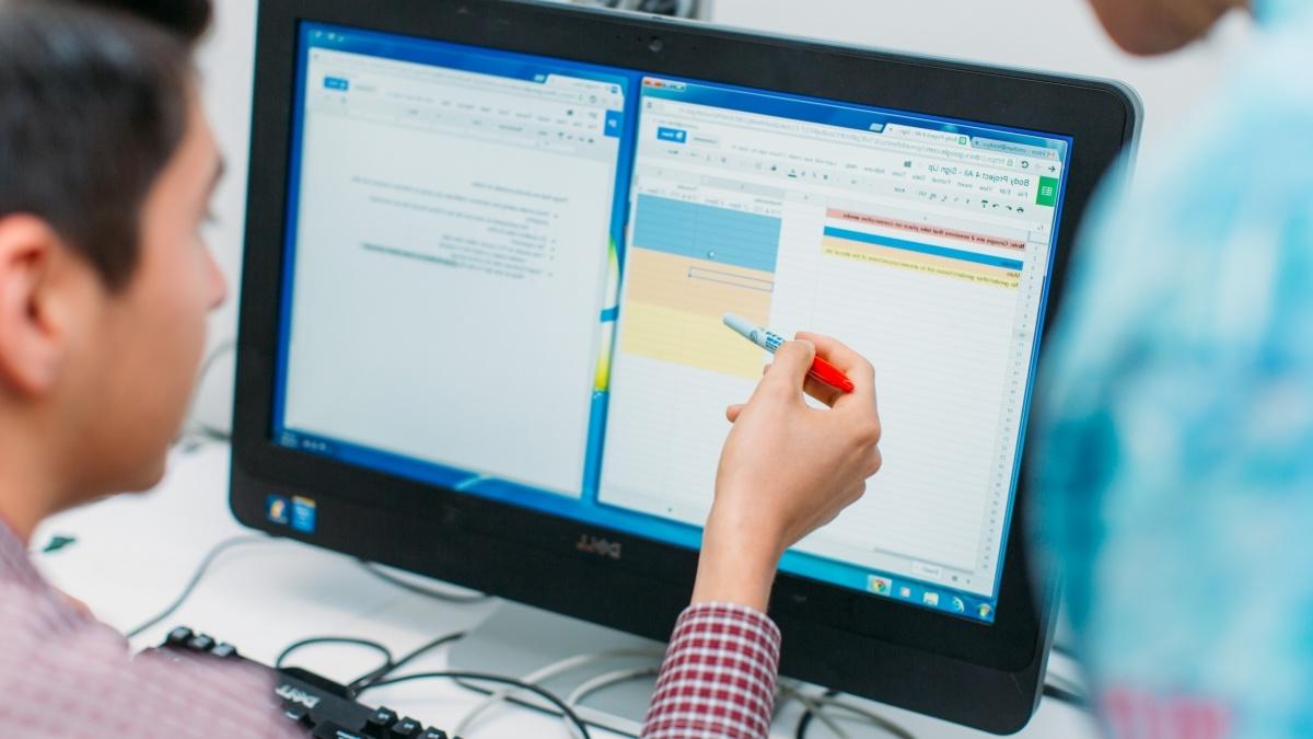 two people looking at computer screen